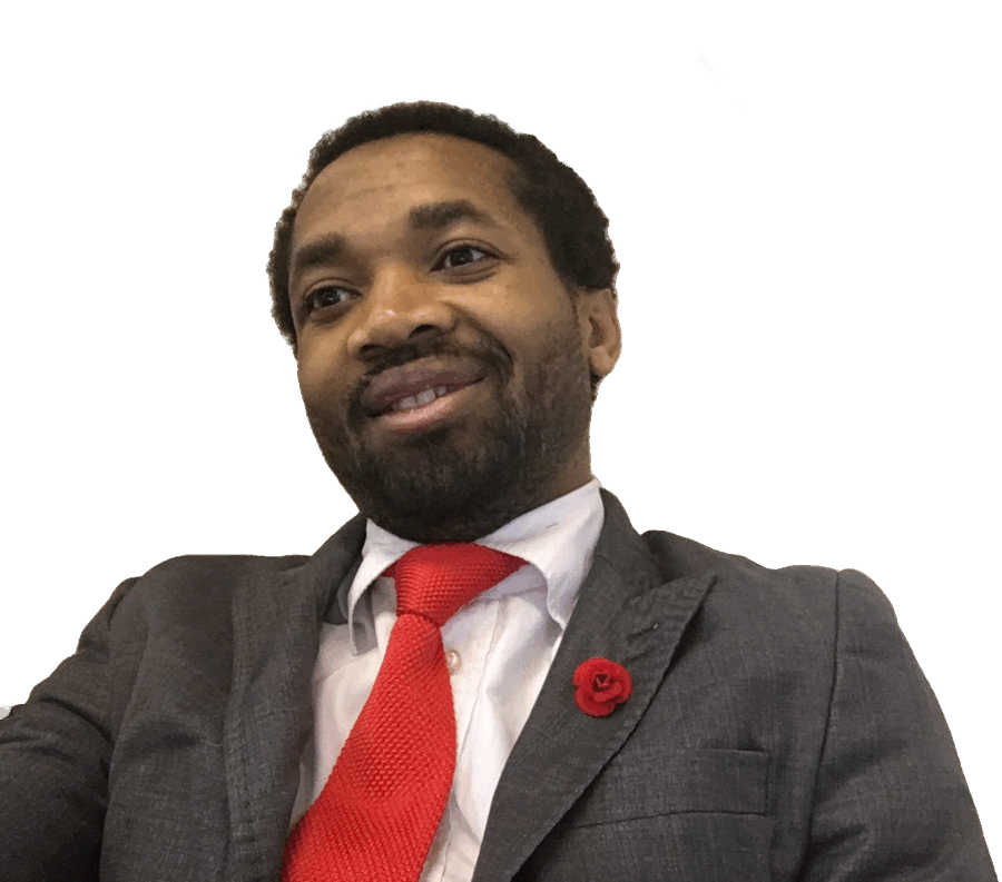 Bestenouf Abba Business wearing a gray suit and red tie.